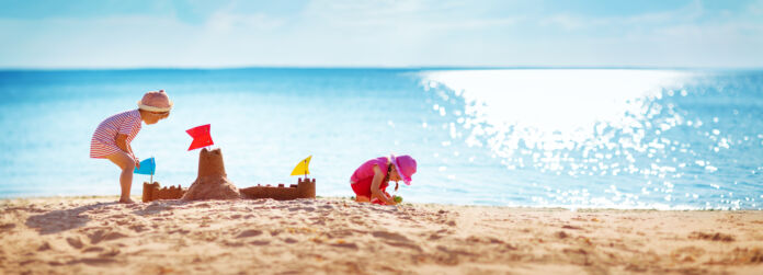 Boy and girl playing on the beach