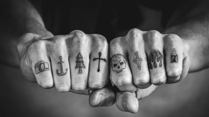 Close,Up,Of,Tattoos,On,Fingers,And,Knuckles.