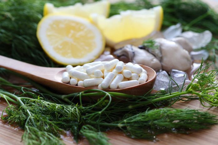 The zinc supplementary white capsule with fresh oyster on block